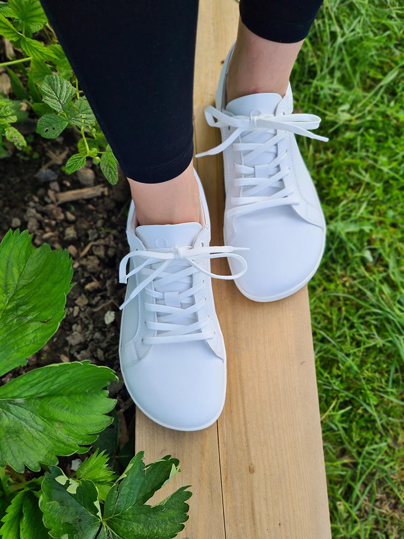 White barefoot sneakers worn outdoors