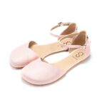 Light pink Mary Jane ballet flats with ankle strap, studio background