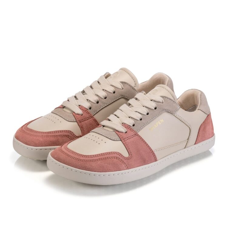 White sneakers with muted pink suede accents on the toe and heel