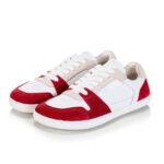 White sneakers with red suede accents on the toe and heel